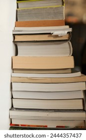 stack of used books in an interior space with natural lighting and copy space, copy text space available