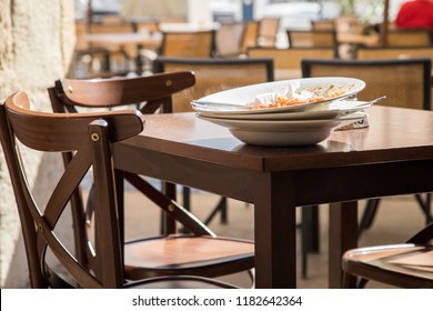 Stack Of Used Dishes Of Restaurant Terrace