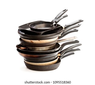 Stack  of used frying pans isolated on white 