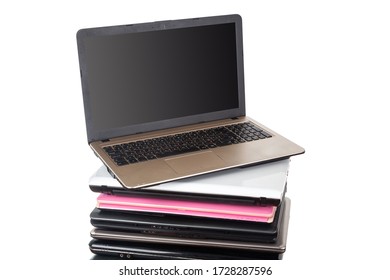 Stack of used laptops in different colors and models. Tha notebooks for repair and service.