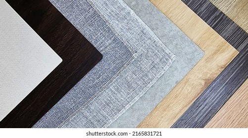 stack of various construction material samples including fabric laminated, grey drapery, wooden laminated and veneer (focused at grey fabric texture). sampler material texture for interior design.