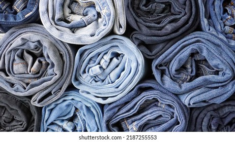 Stack Of Various Shades Of Rolled Up Denim Jeans Background Banner Texture. 