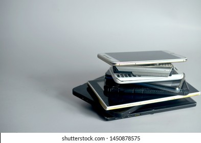 Stack Of Various Smartphone On White Table Background