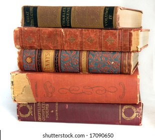 A stack of very old, well read, worn books of poetry and novels.