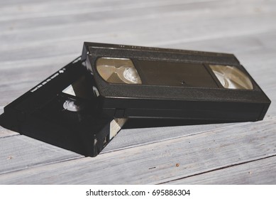  Stack Of VHS Video Tape Cassette On White Wooden Table, Retro Filter