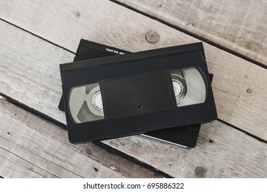  Stack Of VHS Video Tape Cassette On White Wooden Table, Retro Filter