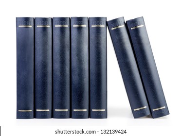 stack of vintage black books in row isolated on white background