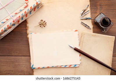 Stack of vintage letters, pen and inkwell on a wooden table. Romantic love letters concept.  - Powered by Shutterstock