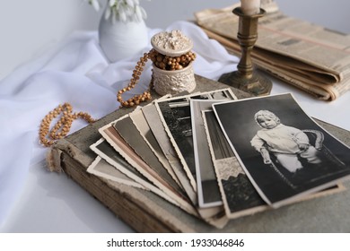 Stack Of Vintage Photos, Baby Photography Of 50s, 60s, Candle Is Lit, First Spring Flowers, Snowdrop, Galanthus In Vase, Concept Of Family Tree, Genealogy, Childhood Memories