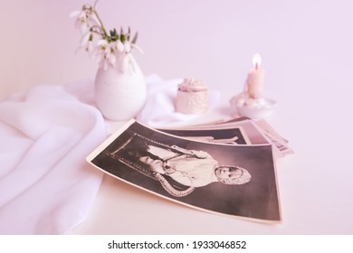 Stack Of Vintage Photos, Baby Photography Of 50s, 60s, Candle Is Lit, First Spring Flowers, Snowdrop, Galanthus In Vase, Concept Of Family Tree, Genealogy, Childhood Memories