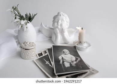 Stack Of Vintage Photos, Baby Photography Of 1960, Selective Focus On Photo, Candle Is Lit, First Spring Flowers, Snowdrop, Galanthus In Vase, Concept Of Family Tree, Genealogy, Childhood Memories