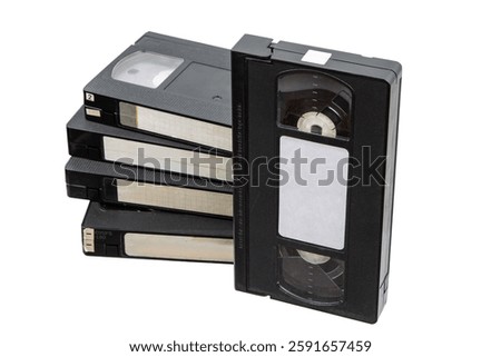 Stack of vintage VHS tapes, black plastic, blank labels, retro media, isolated on white background, nostalgic, analog technology.