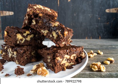 Stack Of Walnut Brownies In Rustic Setting