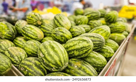 Stack of Watermelons. Watermelons on supermarket shelf. Fresh organic water melon fruit for sale in grocery store. Ripe and fresh watermelons piled up in a store. A lot of watermelons - Powered by Shutterstock