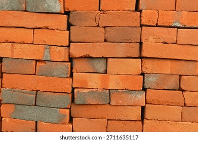 Stack of wet red clay bricks prepared for building a wall, photographed in Bone Bolango, Indonesia