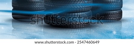 Stack of wheel new black tyres for winter car driving isolated on colored background