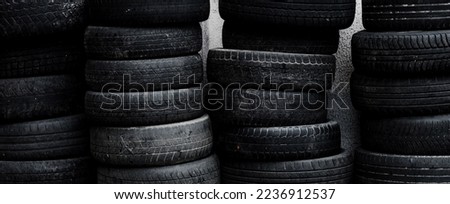 Stack of wheels black tyres outoors