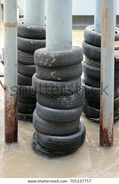Stack of Wheels with\
Pole above the river