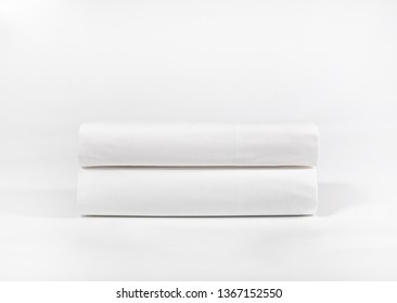 Stack Of White Bedding Or Spa Sheets Against White Backdrop, Folded Soft Bed Clothes, Stack Of White Cotton Towels On A White Background For Advertising, Commercial And Mock Up 