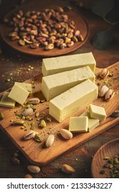 Stack Of White Chocolate Fudge Bars On Wooden Cutting Board