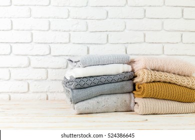 Stack Of White Cozy Knitted Sweaters 