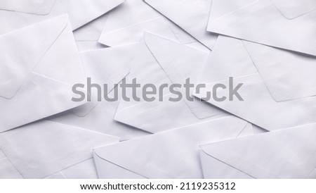 A stack of white envelopes for background.