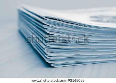 Stack of white journals on table, closeup blue toned