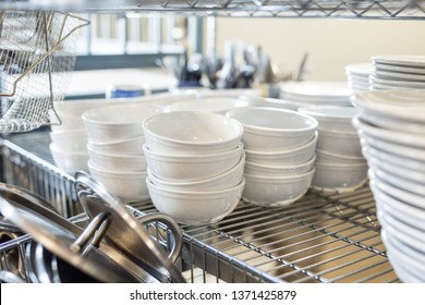 Stack of White Kitchen Bowls on Silver Shelf