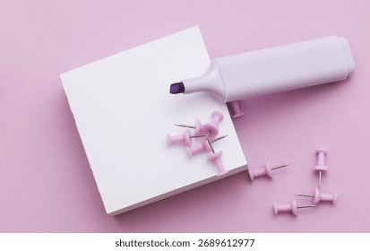 Stack of white memo papers with paper pins and marker on purple background