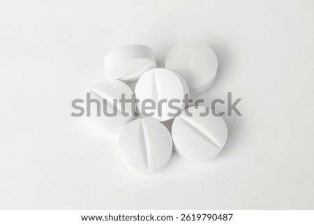 Stack of white paracetamol tablets on clean background, Close-up of several white paracetamol tablets stacked together, isolated on a plain white background, representing healthcare and medicine.