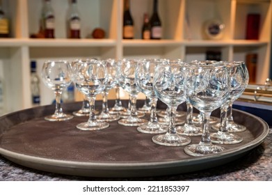 Stack of white plates and empty wine glasses