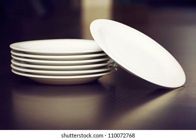 Stack Of White Plates On A Table