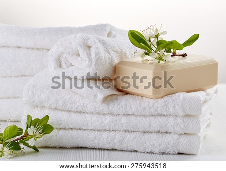 stack of white spa towels and soap bar