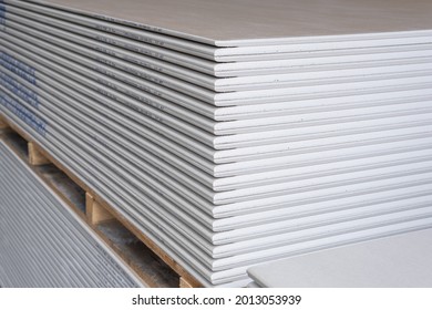 The stack of WHITE Standard Gypsum board panel. Plasterboard. Panel Type A designed for indoor walls, partitions and ceilings, construction site