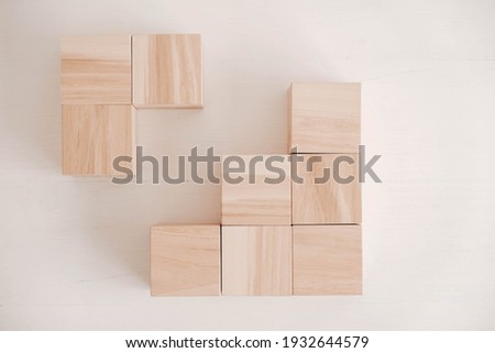 Stack wooden blocks from natural wood on a white background. Top view. Copy, empty space for text.