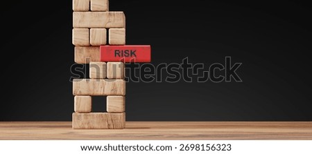 Stack of wooden blocks with one red block labeled RISK symbolizing instability and uncertainty. Concept of business risk, financial danger, investment decision, and risk management.