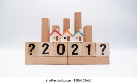 Stack Of Wooden Blocks To Present The Topics On Housing Development, Market, Home Loans, Mortgage Interest Rates And Household Debts In 2021