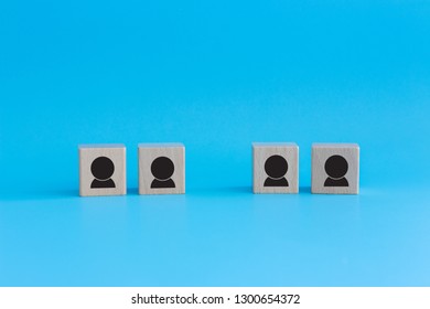 Stack Of Wooden Cubes On Blue Background. Business Concept For Human Resources, Teamwork And Employee Classification