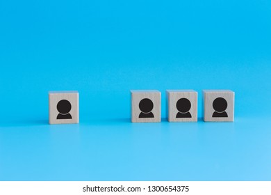 Stack Of Wooden Cubes On Blue Background. Business Concept For Human Resources, Teamwork And Employee Classification