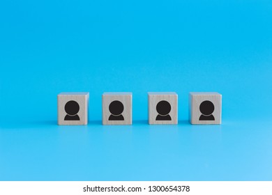 Stack Of Wooden Cubes On Blue Background. Business Concept For Human Resources, Teamwork And Employee Classification