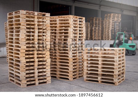 Stack of wooden pallets rack at warehouse storage.