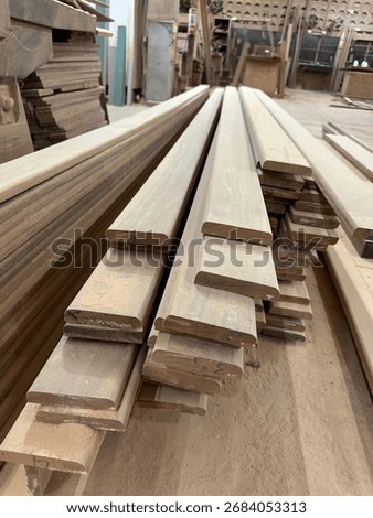 Stack of wooden planks in carpentry workshop