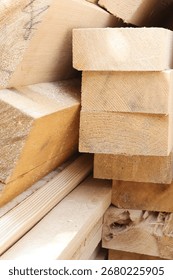 Stack of wooden planks for construction and carpentry. Lumber boards close-up, natural building material for woodworking, architecture projects, and rustic timber background. High quality photo