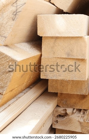Stack of wooden planks for construction and carpentry. Lumber boards close-up, natural building material for woodworking, architecture projects, and rustic timber background. High quality photo