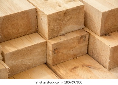 Stack of wooden squared beams for construction. Material for the construction of a wooden building. Closeup big wooden boards