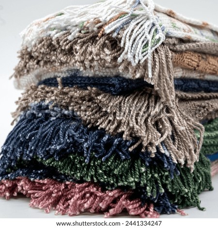 stack of wool knitted throws textured colorful