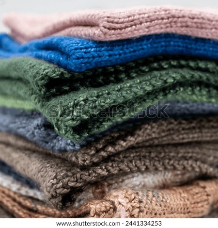 stack of wool knitted throws textured colorful