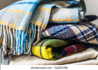 Stack of woolen checked blankets, autumn and winter concept