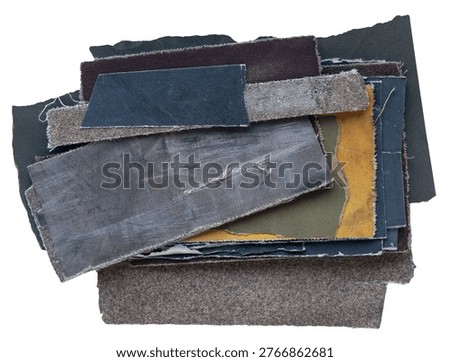 Stack of worn sandpaper sheets with rough textures, frayed edges and different colors isolated on white background