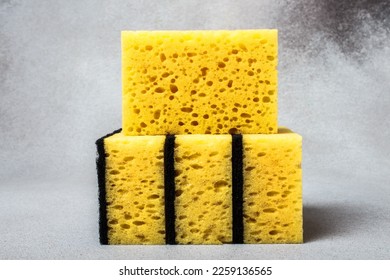 A stack of yellow dishwashing sponges close-up on a neutral gray background. Gentle dishwashing. House cleaning. - Shutterstock ID 2259136565
